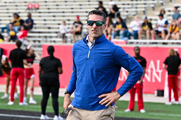 Texans general manager Nick Caserio walks on the sideline prior to the game between the Houston Cougars and the West Virginia Mountaineers at TDECU Stadium.